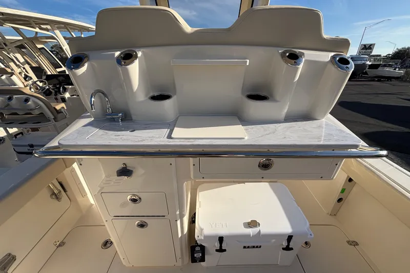  Yacht Photos Pics 2026 Scout 260 LXF boat interior with sink, storage, and Yeti cooler.