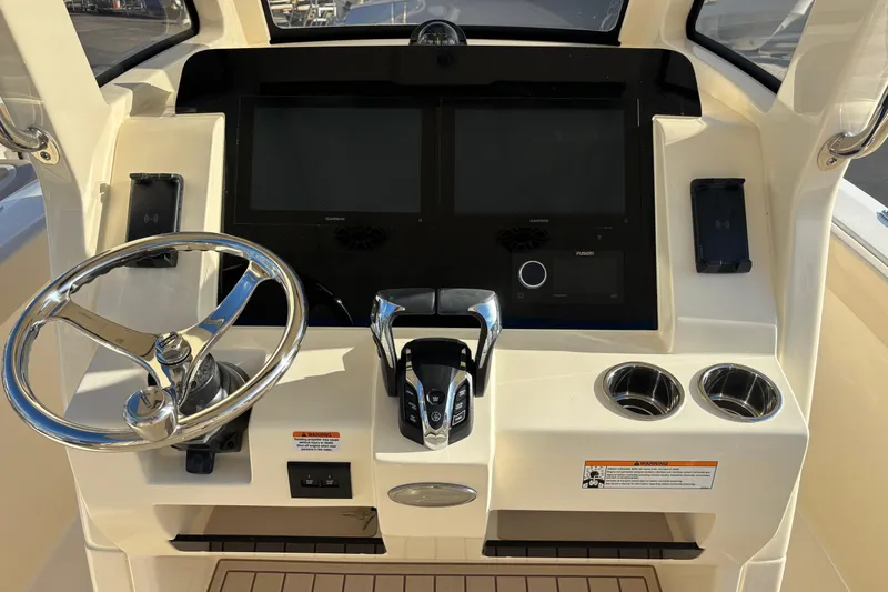  Yacht Photos Pics 2026 Scout 260 LXF boat dashboard with steering wheel, dual screens, and control panel.