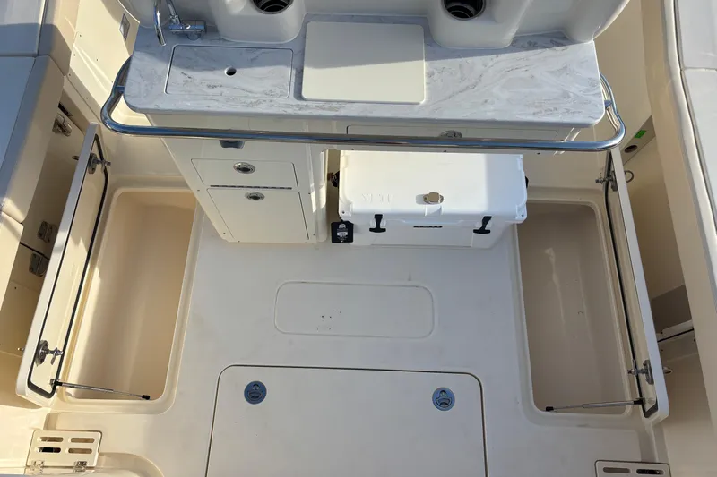  Yacht Photos Pics 2026 Scout 260 LXF boat interior with storage compartments and cooler.