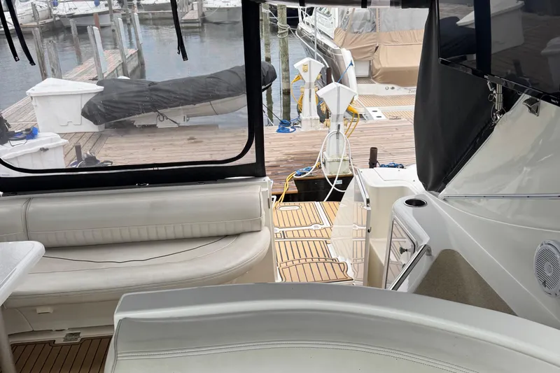 Lubb Shack Yacht Photos Pics 2000 Cruisers Yachts 3870 Express interior with dock view, featuring seating and deck area.