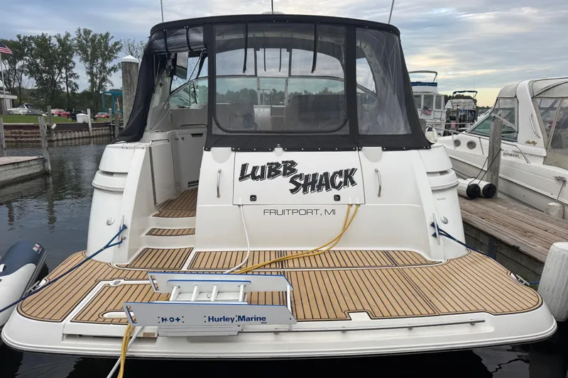 Lubb Shack Yacht Photos Pics 2000 Cruisers Yachts 3870 Express docked, featuring teak decking and custom name "Lubb Shack."