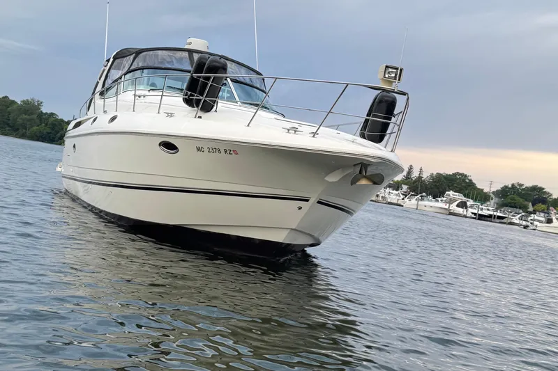 Lubb Shack Yacht Photos Pics 2000 Cruisers Yachts 3870 Express on calm water near marina.