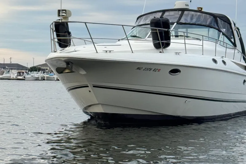 Lubb Shack Yacht Photos Pics 2000 Cruisers Yachts 3870 Express boat docked on calm water.