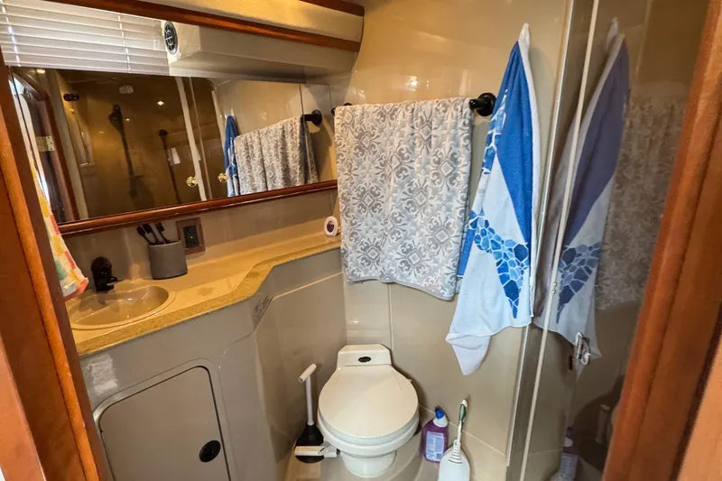 Lubb Shack Yacht Photos Pics Bathroom interior of 2000 Cruisers Yachts 3870 Express with sink, toilet, and shower.