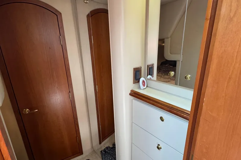 Lubb Shack Yacht Photos Pics Interior of 2000 Cruisers Yachts 3870 Express with wooden doors and mirrored cabinet.