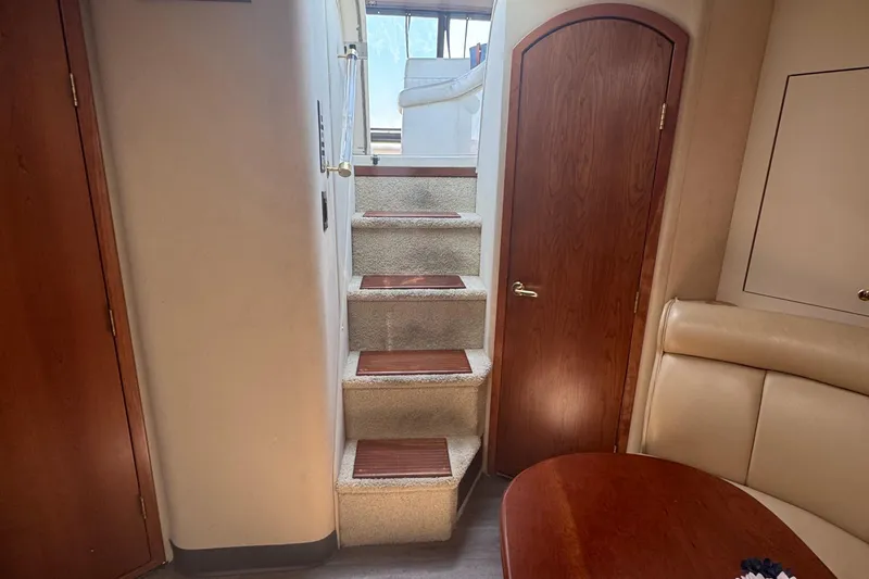 Lubb Shack Yacht Photos Pics Interior of 2000 Cruisers Yachts 3870 Express with stairs and wooden door.