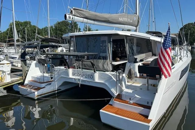 Godspeed Yacht Photos Pics 2023 Nautitech 44 Open catamaran docked, featuring sleek design and American flag.