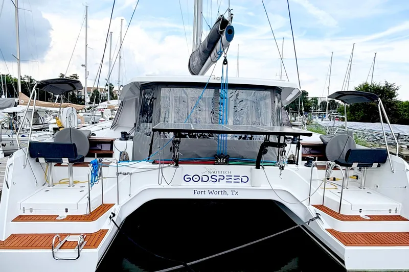Godspeed Yacht Photos Pics 2023 Nautitech 44 Open catamaran docked, rear view with seating and equipment.