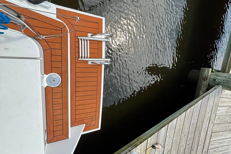 Godspeed Yacht Photos Pics Top view of 2023 Nautitech 44 Open yacht deck near wooden dock.