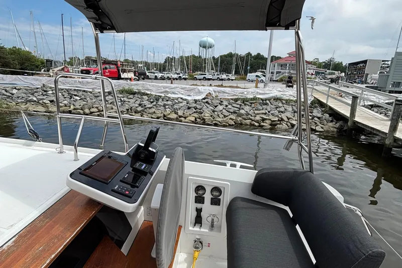 Godspeed Yacht Photos Pics 2023 Nautitech 44 Open catamaran helm with marina view, featuring modern controls and seating.