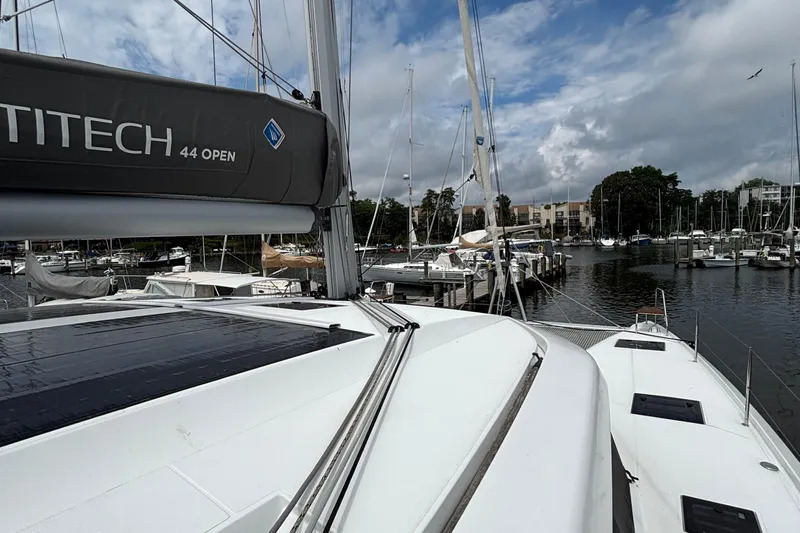Godspeed Yacht Photos Pics 2023 Nautitech 44 Open catamaran docked at a marina under a cloudy sky.