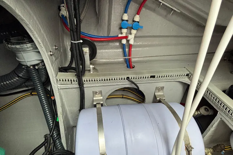 Godspeed Yacht Photos Pics Engine compartment of 2023 Nautitech 44 Open, showcasing wiring and plumbing systems.