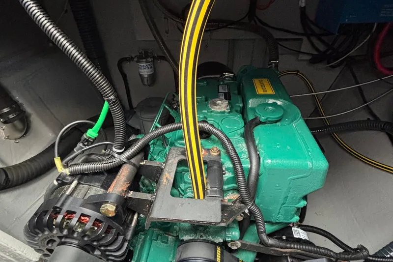 Godspeed Yacht Photos Pics Engine compartment of 2023 Nautitech 44 Open, featuring a green marine engine with visible wiring.