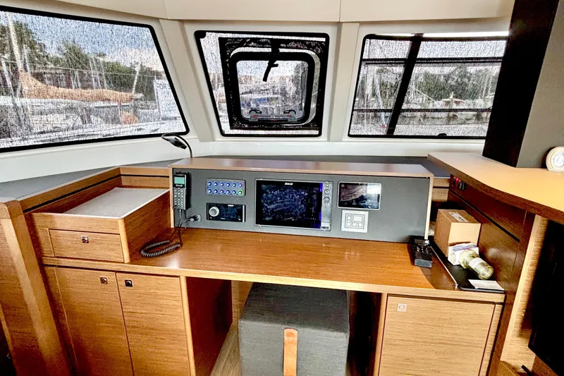 Godspeed Yacht Photos Pics 2023 Nautitech 44 Open yacht interior with navigation equipment and wooden cabinetry.