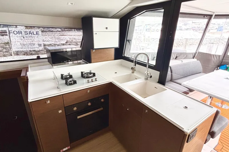 Godspeed Yacht Photos Pics Modern kitchen interior of 2023 Nautitech 44 Open yacht, featuring sleek appliances and spacious design.