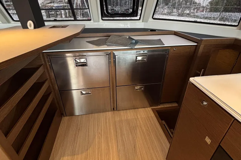Godspeed Yacht Photos Pics Modern kitchen interior of 2023 Nautitech 44 Open yacht with stainless steel appliances.