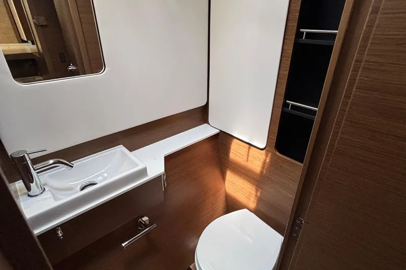 Godspeed Yacht Photos Pics Modern bathroom interior of 2023 Nautitech 44 Open yacht, featuring sleek sink and toilet.
