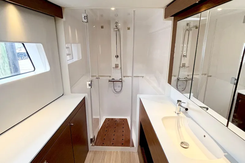 Godspeed Yacht Photos Pics Luxurious bathroom in 2023 Nautitech 44 Open yacht with modern fixtures and wooden accents.