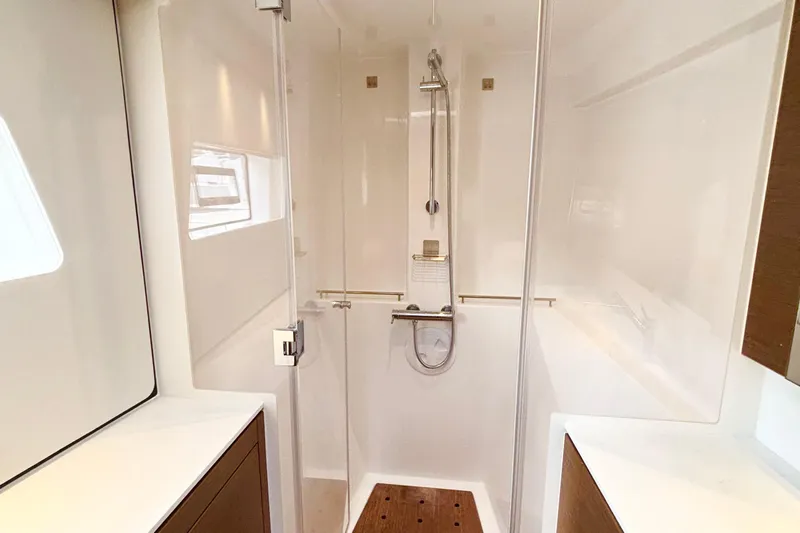 Godspeed Yacht Photos Pics Modern shower area in 2023 Nautitech 44 Open yacht, featuring sleek design and wooden accents.