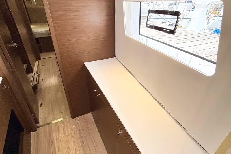 Godspeed Yacht Photos Pics Interior of 2023 Nautitech 44 Open yacht, featuring sleek wood finishes and large window.