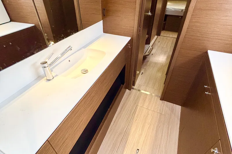 Godspeed Yacht Photos Pics Modern bathroom interior of 2023 Nautitech 44 Open yacht, featuring sleek wood finishes.