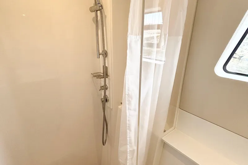 Godspeed Yacht Photos Pics Shower area in 2023 Nautitech 44 Open yacht with modern fixtures and window.