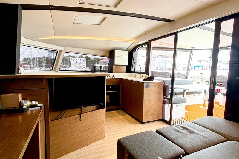 Godspeed Yacht Photos Pics Modern interior of 2023 Nautitech 44 Open yacht with sleek kitchen and lounge area.