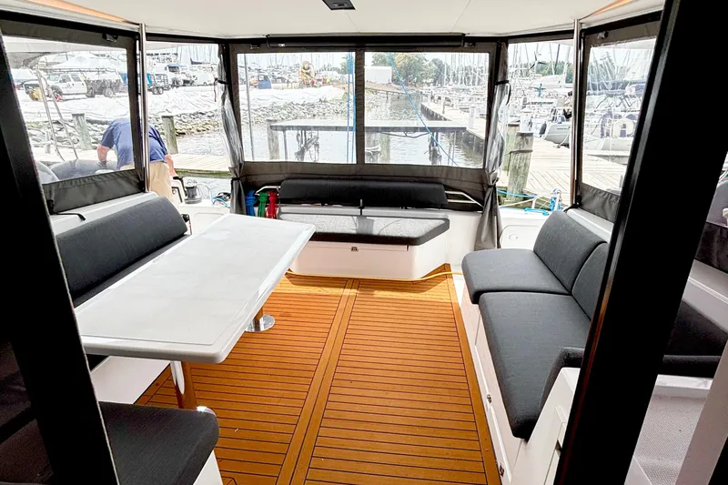 Godspeed Yacht Photos Pics Modern Nautitech 44 Open 2023 yacht interior with sleek seating and wooden flooring.