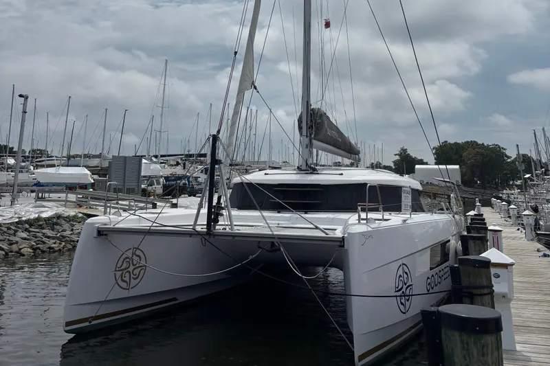 Godspeed Yacht Photos Pics 2023 Nautitech 44 Open catamaran docked at a marina under cloudy skies.