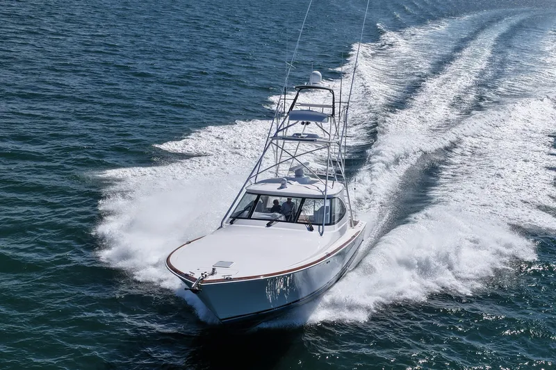 Pamela Yacht Photos Pics 2024 Viking 48 Sport Tower yacht cruising on open water.