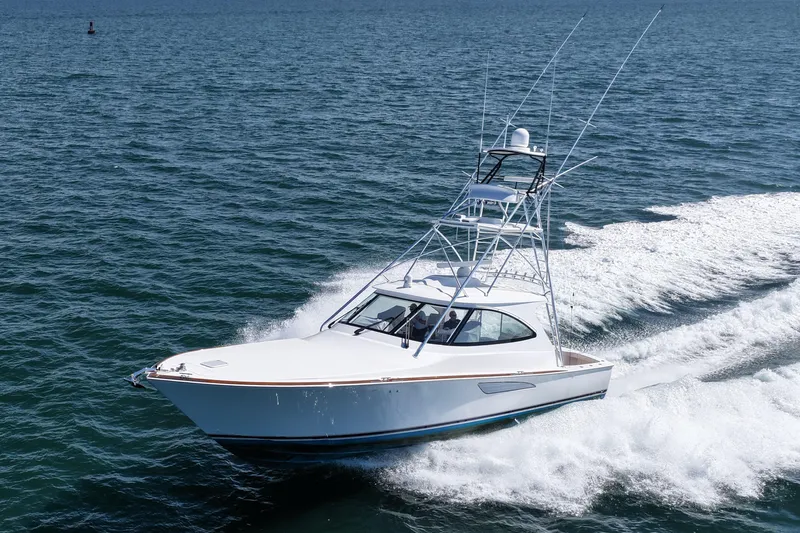 Pamela Yacht Photos Pics 2024 Viking 48 Sport Tower yacht cruising on open water.