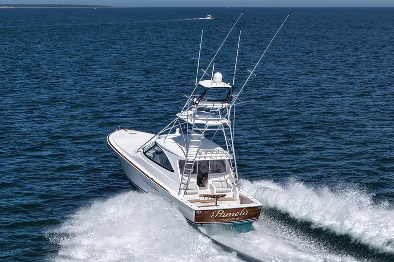 Pamela Yacht Photos Pics 2024 Viking 48 Sport Tower cruising on open water, creating a dynamic wake.