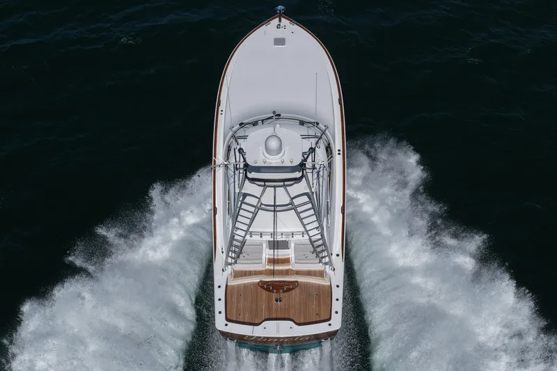 Pamela Yacht Photos Pics 2024 Viking 48 Sport Tower yacht cruising on open water, aerial view.