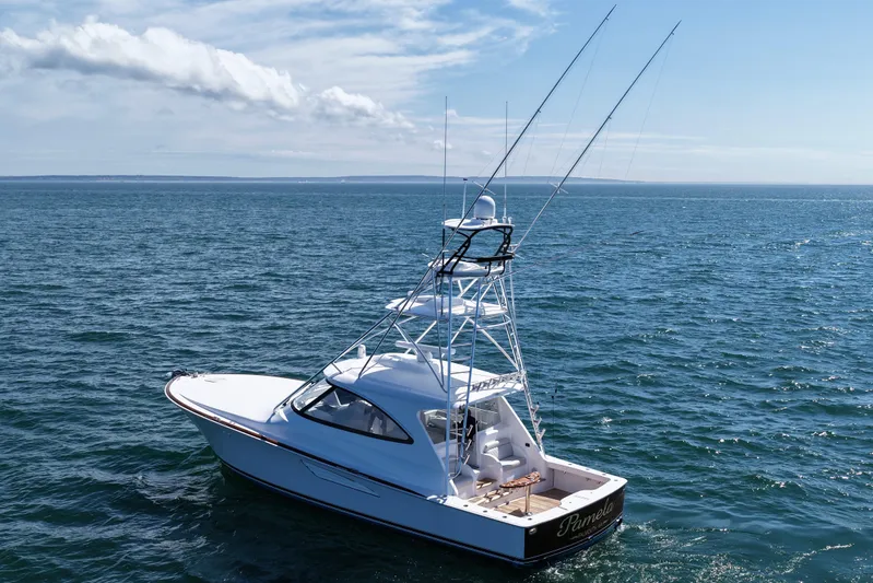 Pamela Yacht Photos Pics 2024 Viking 48 Sport Tower yacht cruising on open sea under clear skies.