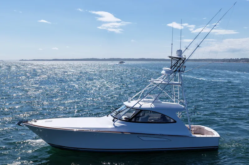 Pamela Yacht Photos Pics 2024 Viking 48 Sport Tower yacht cruising on open water under clear skies.
