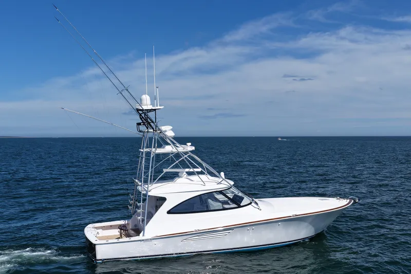 Pamela Yacht Photos Pics 2024 Viking 48 Sport Tower yacht cruising on open sea under clear blue sky.