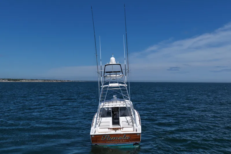 Pamela Yacht Photos Pics 2024 Viking 48 Sport Tower yacht on open sea under clear blue sky.