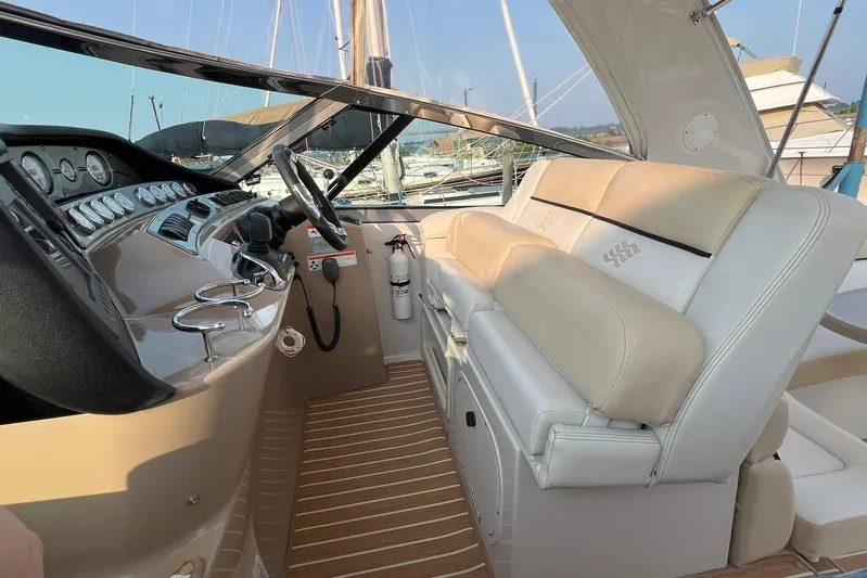  Yacht Photos Pics 2008 Four Winns 378 Vista yacht cockpit with steering wheel and beige seating.