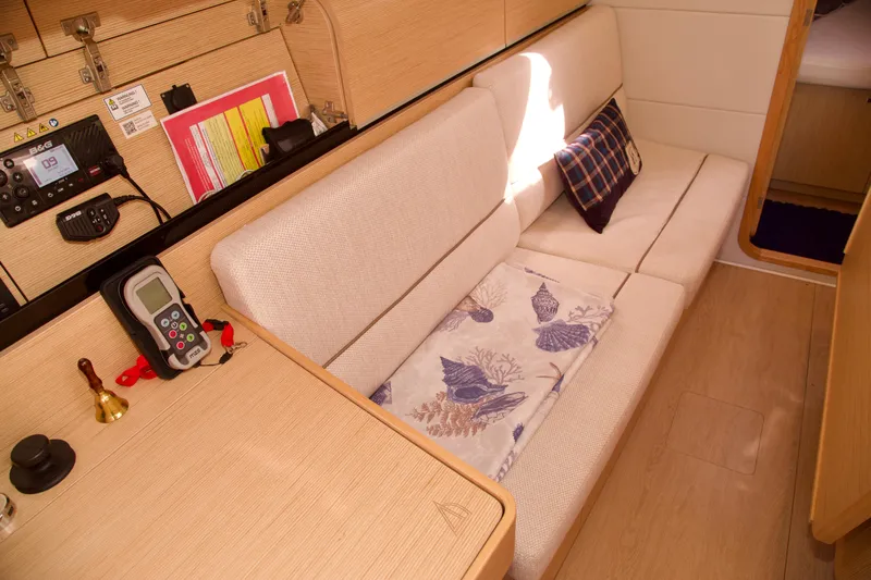  Yacht Photos Pics Interior of 2021 Hanse Dehler 38SQ yacht with cozy seating and navigation equipment.