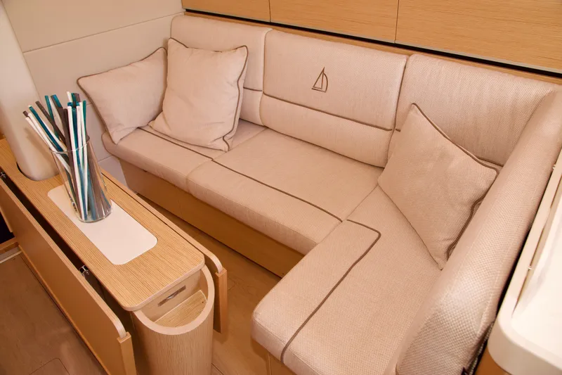  Yacht Photos Pics 2021 Hanse Dehler 38SQ yacht interior with beige seating and modern design.