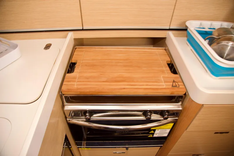  Yacht Photos Pics Compact kitchen area in 2021 Hanse Dehler 38SQ yacht with stove and sink.