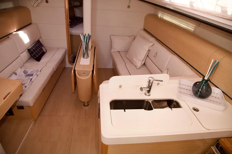  Yacht Photos Pics Interior of 2021 Hanse Dehler 38SQ yacht with modern kitchen and cozy seating area.