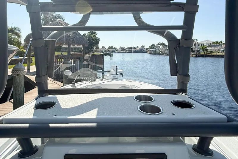  Yacht Photos Pics 2022 Yellowfin 26 Hybrid boat docked by a scenic waterfront.