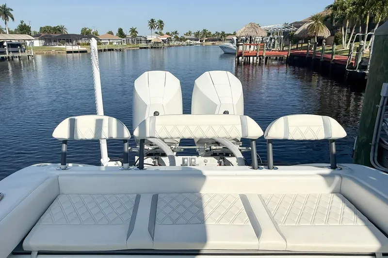  Yacht Photos Pics 2022 Yellowfin 26 Hybrid boat with dual engines on a calm waterway.