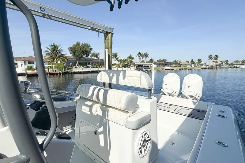  Yacht Photos Pics 2022 Yellowfin 26 Hybrid boat on calm water, featuring sleek design and modern amenities.