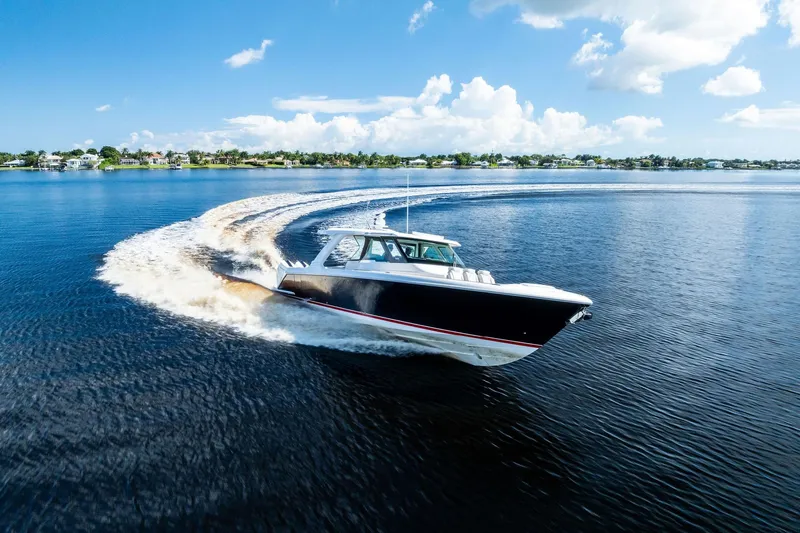 Moonrunner Yacht Photos Pics 2024 Tiara Yachts 48 LS cruising on a sunny day, creating a dynamic water trail.