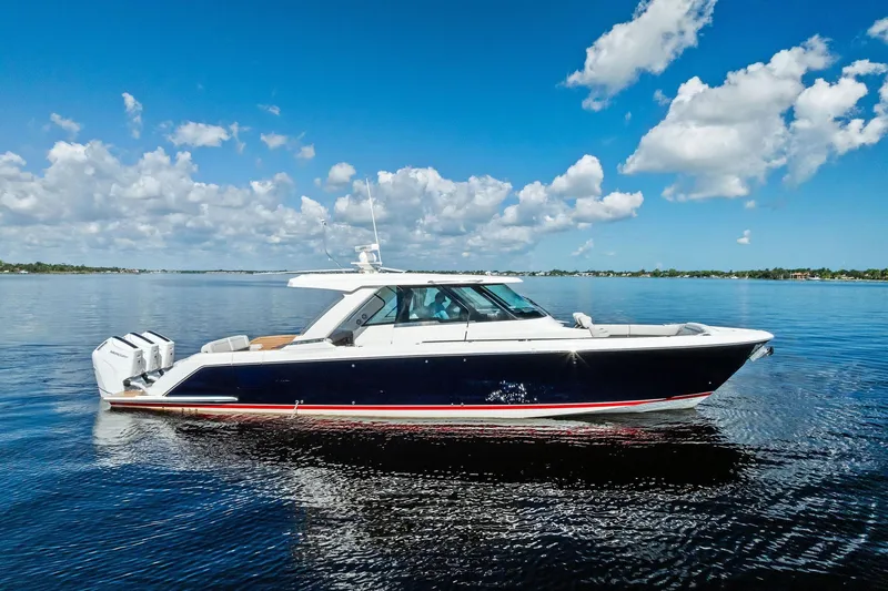 Moonrunner Yacht Photos Pics 2024 Tiara Yachts 48 LS cruising on a calm, sunny day with blue skies.
