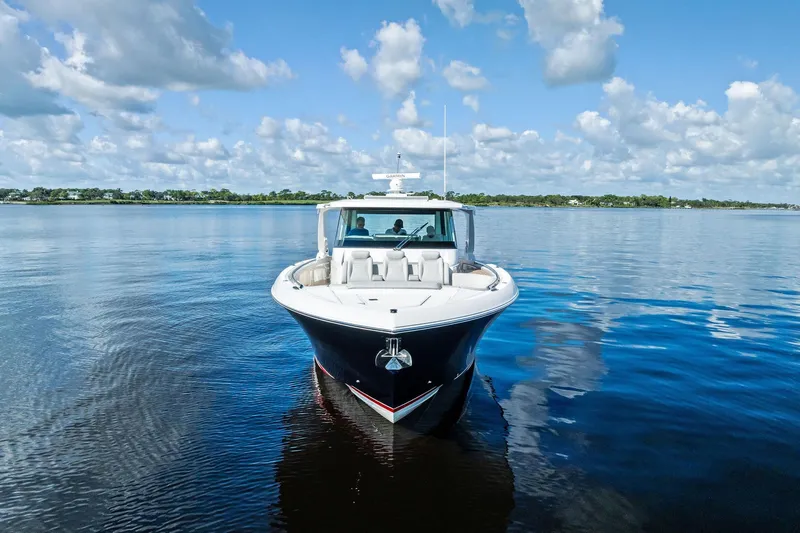 Moonrunner Yacht Photos Pics 2024 Tiara Yachts 48 LS cruising on calm waters under a partly cloudy sky.