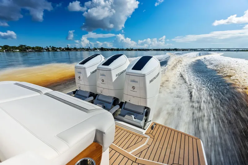 Moonrunner Yacht Photos Pics 2024 Tiara Yachts 48 LS cruising with powerful Mercury outboard engines on a sunny day.