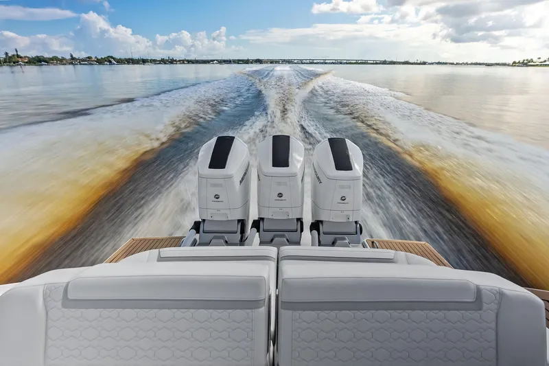 Moonrunner Yacht Photos Pics 2024 Tiara Yachts 48 LS cruising with powerful outboard engines, leaving a dynamic wake.